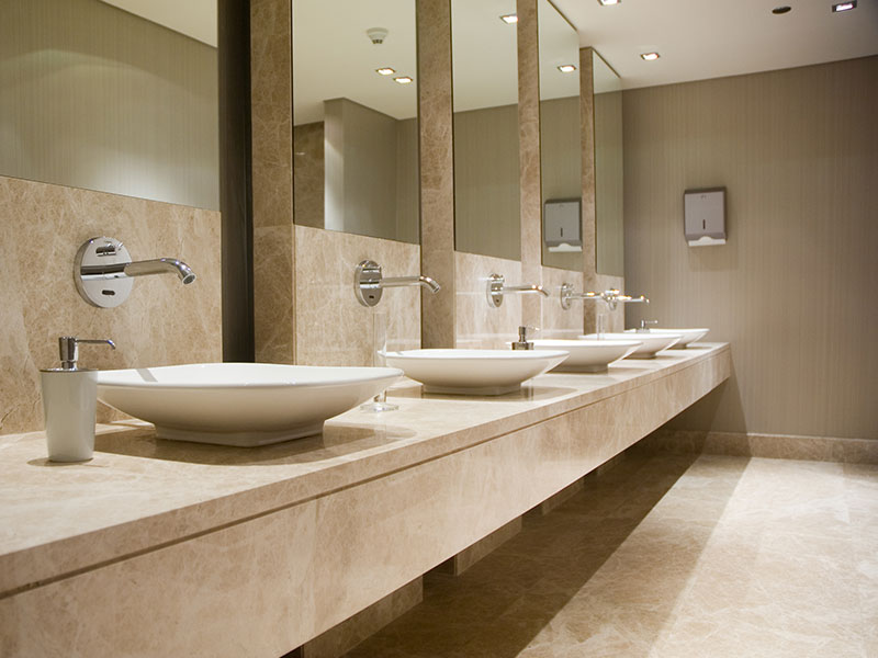 The A1 Granite team professionally installing a new granite countertop during a bathroom remodeling.