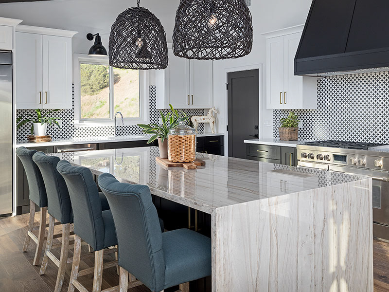 Airdrie open-concept kitchen with large granite island and matching countertops fabricated by A1 Granite & Marble.